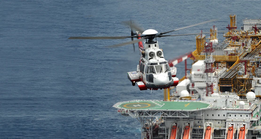 helicopter taking off from oil rig